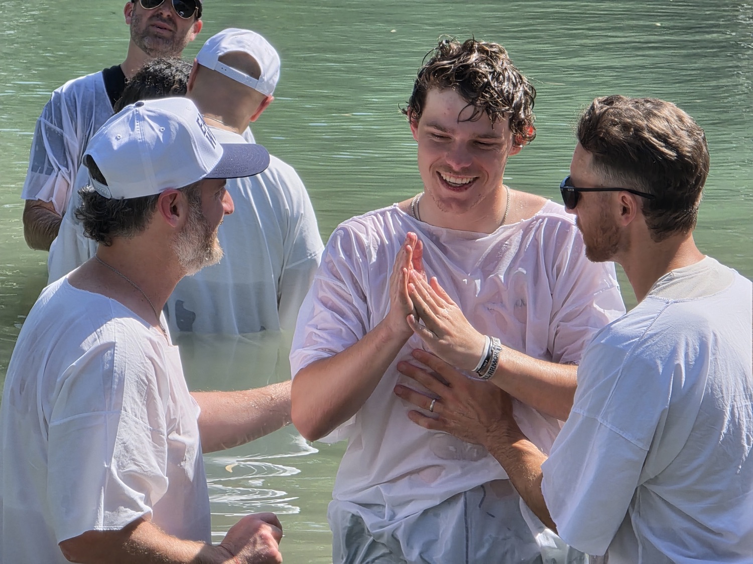 Hands laid on in the water