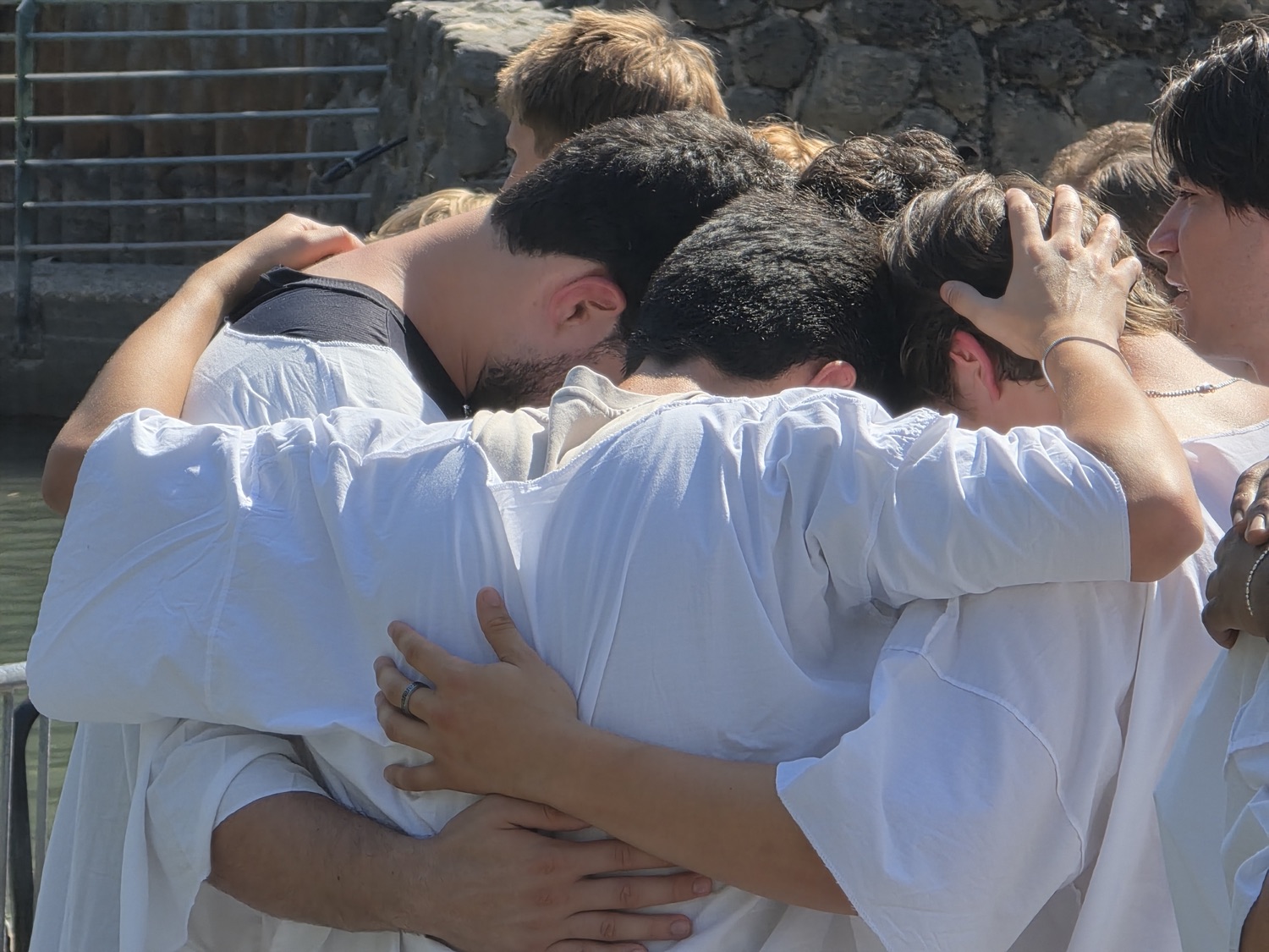 Arms around each other in the river