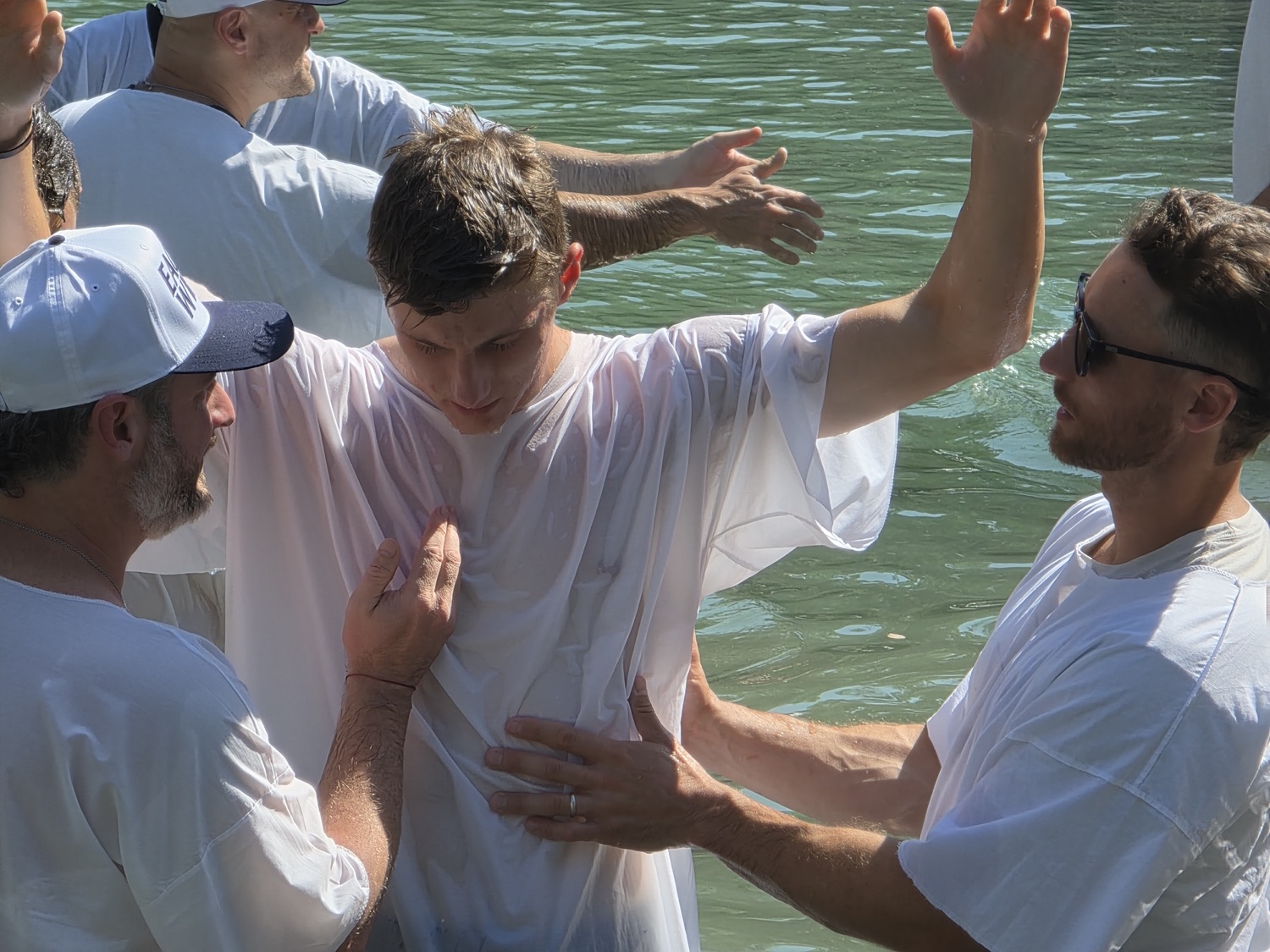 Hands lifted over the water